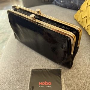 HOBO clutch in black and gold. Measurements= 9x4.75 inches. Pristine condition.